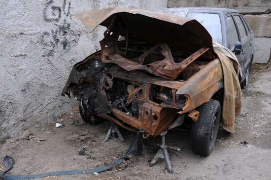 Wrecked rusty car ready for salvage and removal